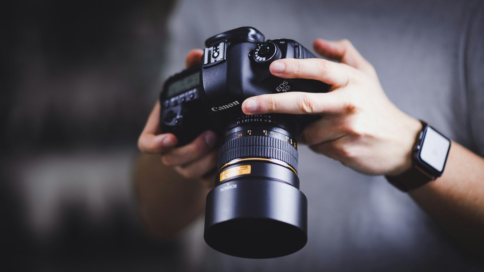 Photographer holding a camera with both hands