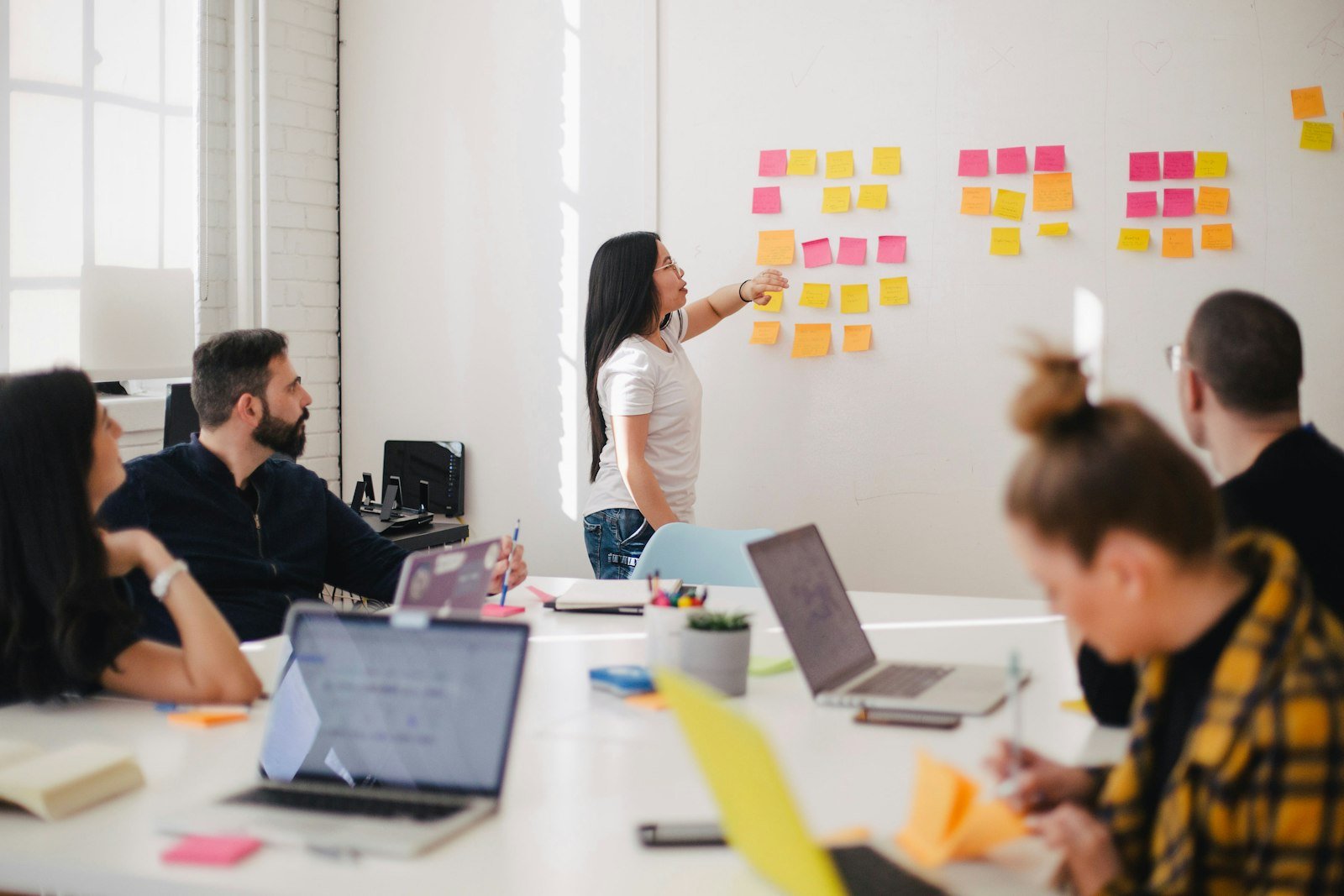 Team planning together with sticky notes on a whiteboard